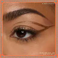 Eye close-up showcasing dramatic winged liner applied with metallic finish of NYX Professional Makeup Holiday Candy Swirl Liner in shade 01 Spice Spice Baby